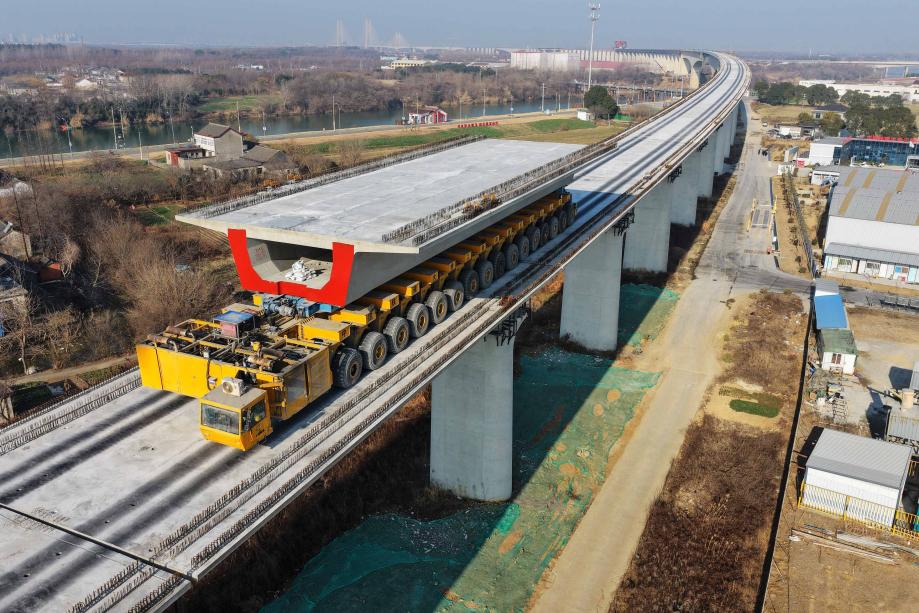 15 جنوری 2026 ۔ شنگھائی-چھونگ چنگ-چھنگ دو ہائی سپیڈ ریلوے کے یانگ جو سیکشن پر، ایک بیم لانچنگ مشین تعمیراتی سائٹ پر پری کاسٹ باکس گرڈرز منتقل کررہی ہے۔ (تصویر/مینگ دی لونگ)