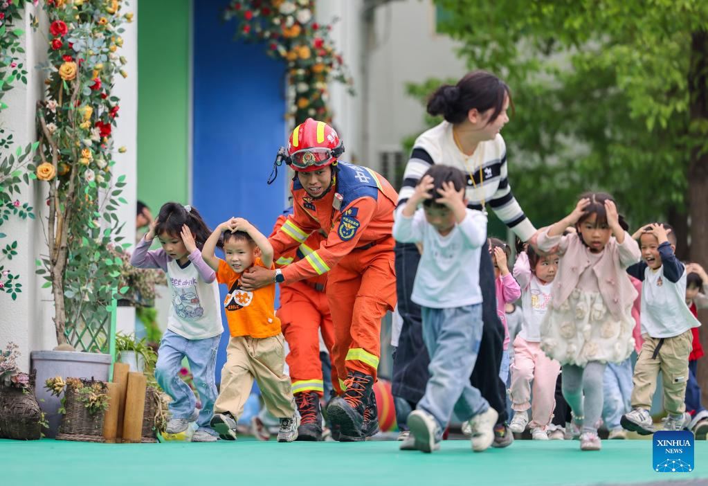 چین کے صوبے گوئے جو کی یو پھنگ دونگ خود اختیار کاونٹی کے ایک کنڈر گارٹن میں  بچے ، اساتذہ اور تربیت یافتہ امدادی کارکنوں  کی رہنمائی  میں ، زلزلے کی صورت میں  ہنگامی انخلا کی مشق کر رہے ہیں۔  (حو پھین شوئے۔ شنہوا)